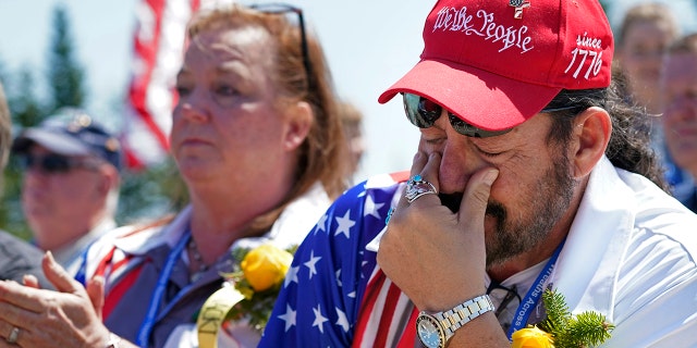 John Biernacki of Greenville, Texas, wipes tears during the unveiling of a monument to honor the military passengers of Flying Tiger Line Flight 739, Saturday, May 15, 2021, in Columbia Falls, Maine. His father, MSgt., Henry Biernacki, was among those killed on the secret mission to Vietnam in 1962. (Associated Press)