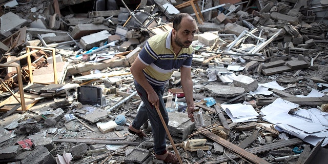 A Palestinian man inspects the damage of a house destroyed by an early morning Israeli airstrike, in Gaza City, Tuesday, May 18, 2021. (Associated Press)