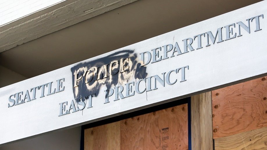 The word "people" is spray-painted over the word "police" on the closed Seattle Police Department's East Precinct surrounded by the area known as the Capitol Hill Autonomous Zone (CHAZ), in Seattle, Washington, on June 11, 2020. 