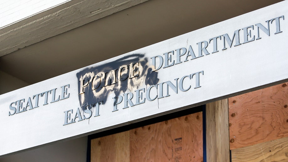 The word "people" is spray-painted over the word "police" on the closed Seattle Police Department's East Precinct surrounded by the area known as the Capitol Hill Autonomous Zone (CHAZ), in Seattle, Washington, on June 11, 2020. 