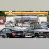 Customers fill up their vehicles with fuel at the Cupboard Food Store, foreground, and the Duck-Thru in Scotland Neck, North Carolina, on Tuesday, May 11, 2021. Both stations were doing a brisk business on Tuesday as news of the cyberattack on the Colonial Pipeline spread fear of a gas shortage in rural North Carolina.
