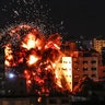 An explosion among buildings during an Israeli airstike on Gaza City on May 4, 2021. Gaza militants fired a barrage of rockets at Israel, which responded with airstrikes, officials said, as a fragile ceasefire again faltered. (MAHMUD HAMS/AFP via Getty Images)