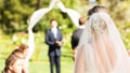 TikTokers are defending a groom who checked his phone while his bride was walking down the aisle during their wedding ceremony. (iStock)