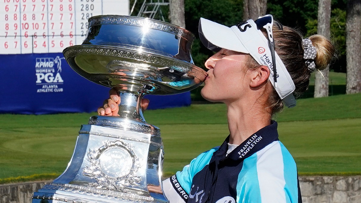 Nelly Korda of the U.S. kisses the trophy after winning the KPMG Women's PGA Championship golf tournament, Sunday, June 27, 2021, in Johns Creek, Ga. (AP Photo/John Bazemore)