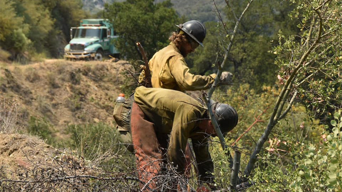 A group of firefighting monks was ready to defend a Buddhist monastery being threatened Tuesday by a wildfire burning in the rugged central coast mountains south of Big Sur.