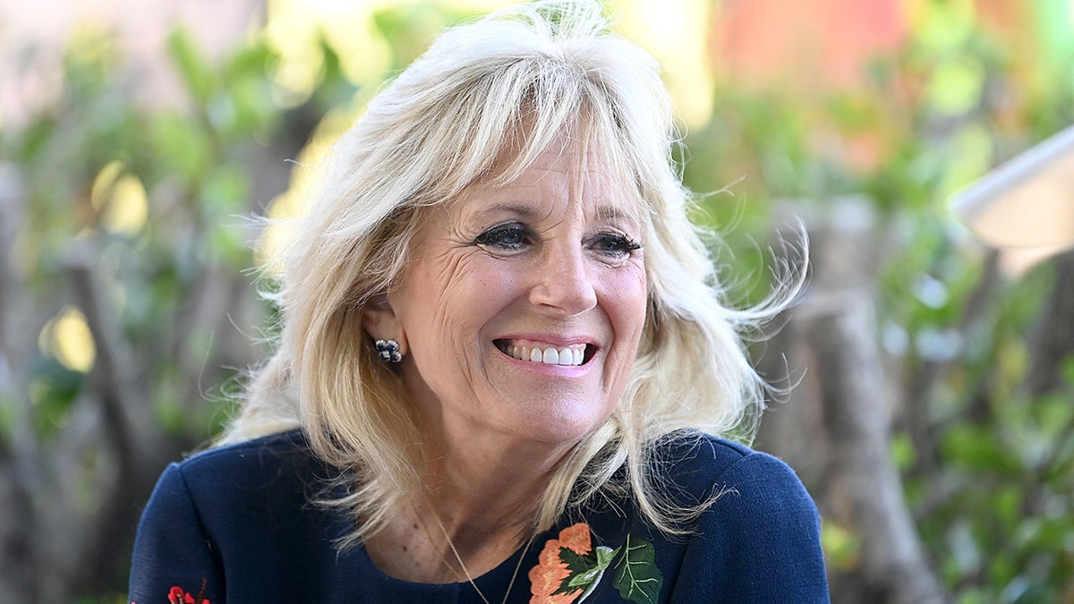 US First Lady Jill Biden smiles as she meets military surfers in Newlyn, Cornwall on the sidelines of the G7 summit on June 12, 2021. - US First Lady Jill Biden met with veterans, first responders, and family members of Bude Surf Veterans, a Cornwall-based volunteer organization that provides social support and surfing excursions for veterans, first responders and their families. (Photo by DANIEL LEAL-OLIVAS / POOL / AFP) (Photo by DANIEL LEAL-OLIVAS/POOL/AFP via Getty Images)