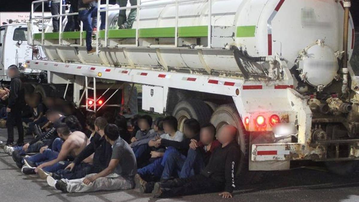 Alleged illegal immigrants are seen outside a gas tanker near Laredo, Texas, on Friday after Border Patrol agents thwarted a human smuggling operation, authorities say. (Customs and Border Protection)