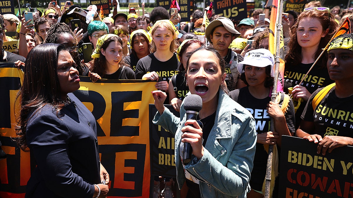 WASHINGTON, DC - JUNE 28: Rep. Cori Bush (D-MO) (L) and Rep. Alexandria Ocasio-Cortez (D-NY) rallying hundreds of young climate activists in Lafayette Square on the north side of the White House to demand that U.S. President Joe Biden work to make the Green New Deal into law on June 28, 2021 in Washington, DC. Organized by the Sunrise Movement, the 'No Climate, No Deal' marchers demanded a meeting with Biden to insist on an 'infrastructure package that truly invests in job creation and acts to combat the climate crisis.' (Photo by Chip Somodevilla/Getty Images)