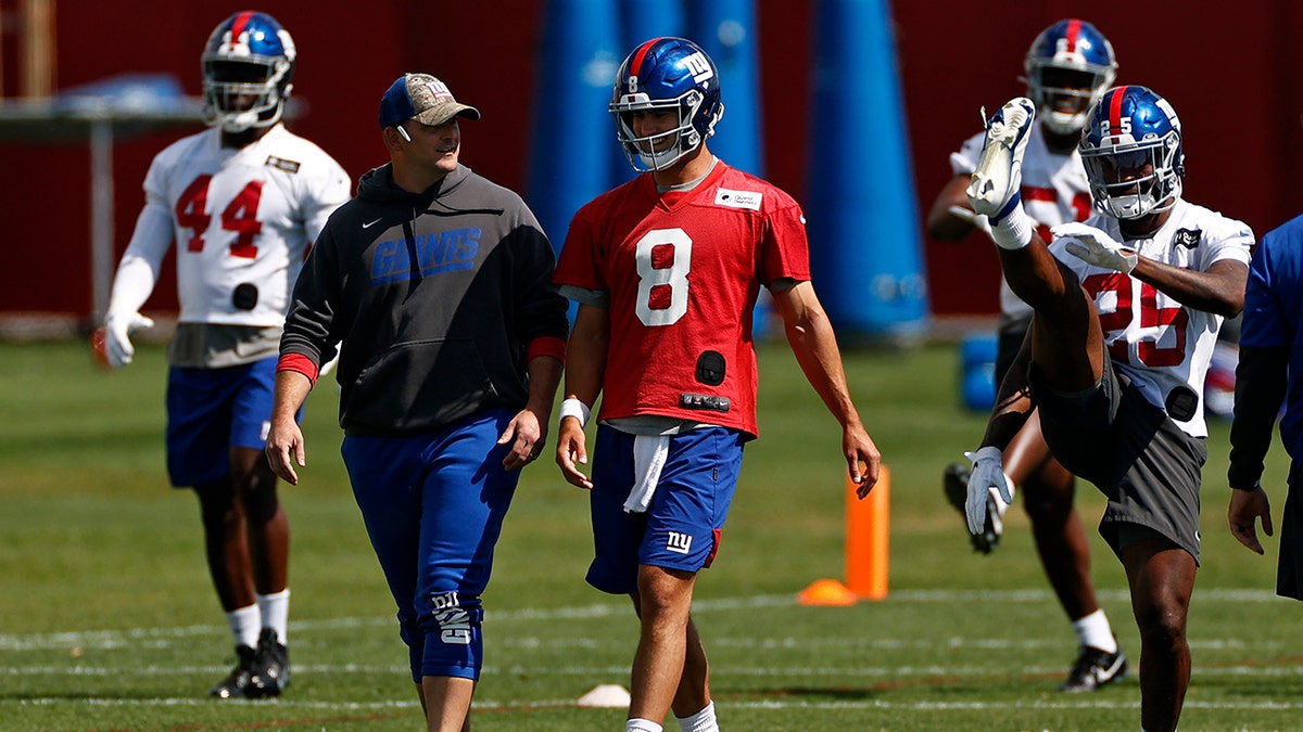 New York Giants quarterback Daniel Jones (8) talks with head coach Joe Judge during NFL football practice in East Rutherford, New Jersey, Thursday, May 27, 2021. (AP Photo/Adam Hunger)