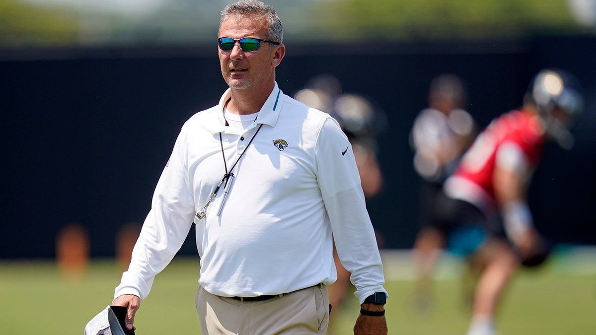 Jacksonville Jaguars head coach Urban Meyer watches players go through drills during an NFL football team practice, Thursday, May 27, 2021, in Jacksonville, Fla. (AP Photo/John Raoux)