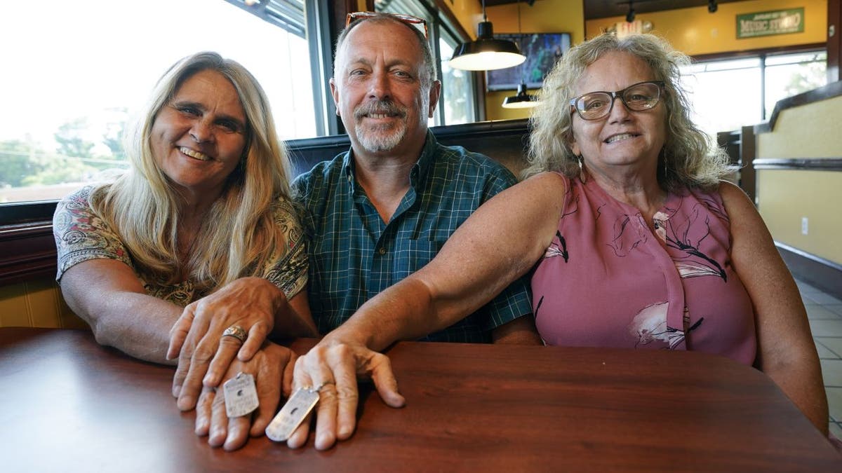 Debby-Neal, Jim Strickland and Mylaen Merthe reunited at a restaurant in Ocala, Fla., on Tuesday, May 25, 2021. (AP Photo/John Raoux)