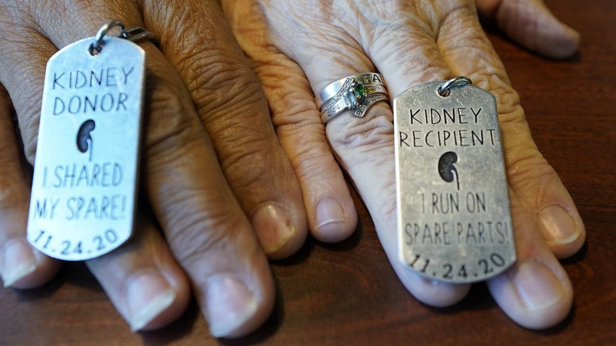 Debby-Neal Strickland and Mylaen Merthe show off the donor/recipient tags they had made following the kidney donation. (AP Photo/John Raoux)