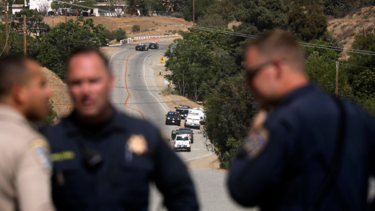 Law enforcement authorities close off a road during an investigation for a shooting at fire station 81 in Santa Clarita, Calif., on Tuesday, June 1, 2021. An off-duty Los Angeles County firefighter fatally shot a fellow firefighter and wounded another at their fire station Tuesday before barricading himself at his home nearby, where a fire erupted and he was later found dead, authorities said. (AP Photo/David Swanson)