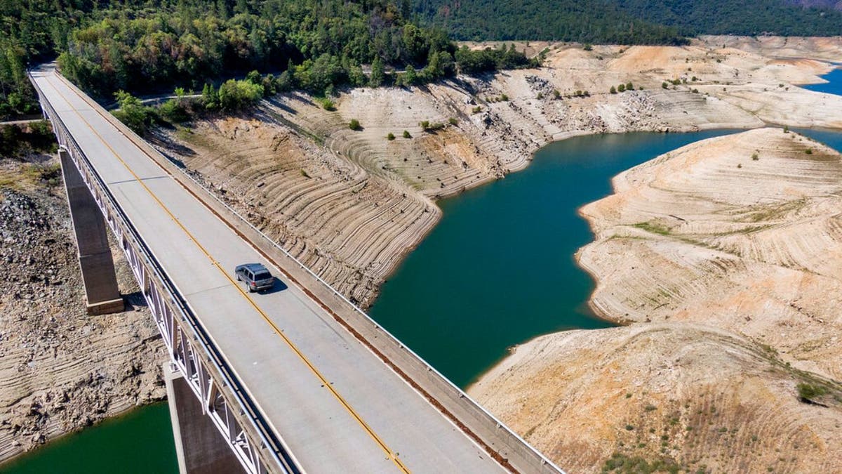 A car crosses Enterprise Bridge over Lake Oroville's dry banks Sunday, May 23, 2021, in Oroville, California. At the time of this photo, the reservoir was at 39 percent of capacity and 46 percent of its historical average. (Associated Press)
