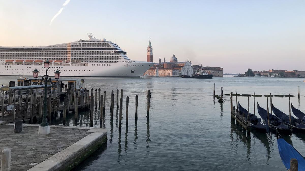 The MSC Orchestra cruise ship from MSC Cruises passes through the Giudecca Canal in Venice, Italy, on Thursday, June 3, 2021. It is the first ship to sail down the canal during the COVID-19 pandemic. (JC Viens via AP)