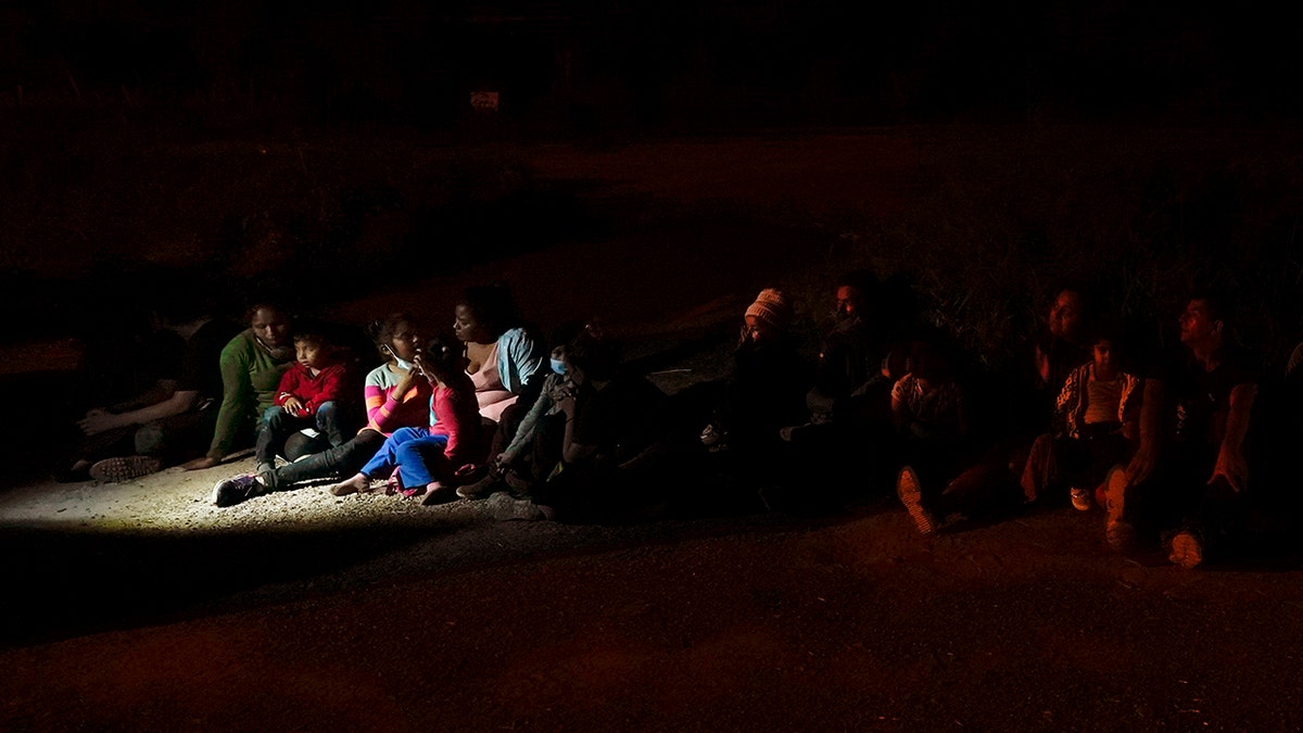 Migrants mainly from Honduras and Nicaragua sit in line after turning themselves in upon crossing the U.S.-Mexico border Monday, May 17, 2021, in La Joya, Texas. (Associated Press)
