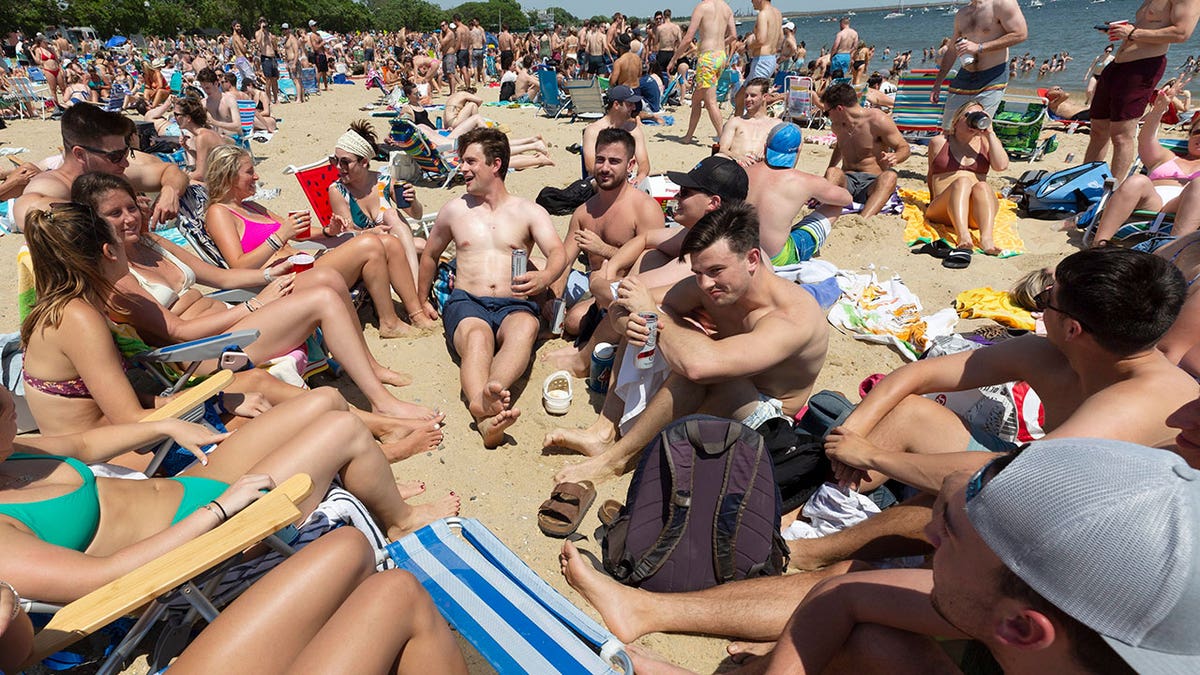 Crowds gather on L Street Beach, Saturday, June 5, 2021, in the South Boston neighborhood of Boston.
