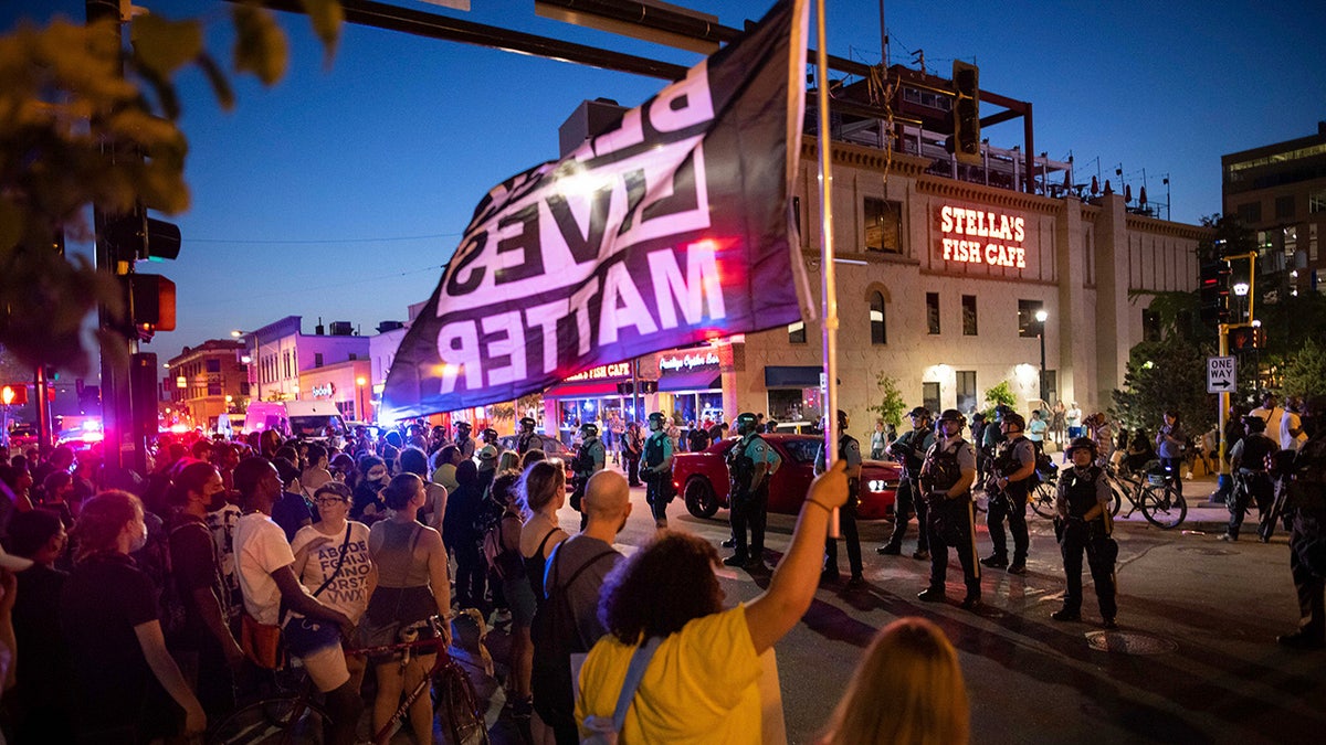 Community members face off against police, late Sunday, June 6, 2021, in Minneapolis, as they demand justice for Winston Boogie Smith Jr., who was fatally shot by members of a U.S. Marshals task force several days earlier. (AP Photo/Christian Monterrosa)