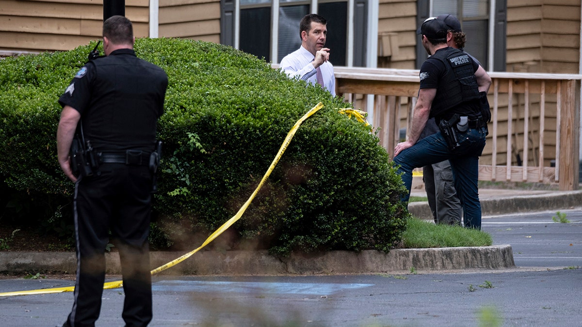 Law enforcement officers wait outside of a Sandy Springs, Ga., apartment where Gary Creek died Tuesday, June 8, 2021, following a SWAT standoff. (AP Photo/Ben Gray)