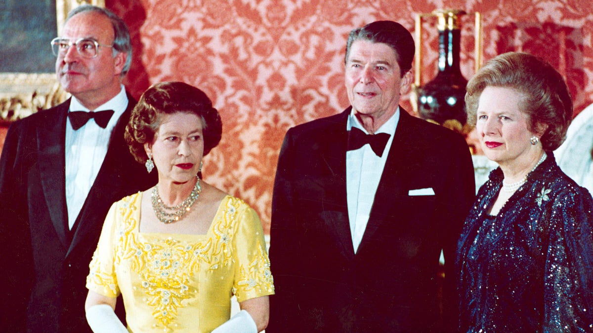 The June 10, 1984, file photo shows Queen Elizabeth II, second left, standing with West German Chancellor Helmut Kohl, left, U.S. President Ronald Reagan, second right, and Britain's Prime Minister Margaret Thatcher at London's Buckingham Palace, prior to a dinner for summit leaders. (AP Photo, File)