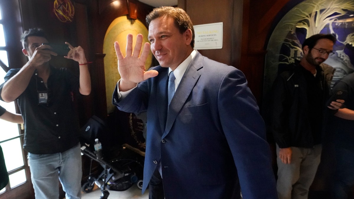 Florida Gov. Ron DeSantis, waves as he arrives, Monday, June 14, 2021, at the Shul of Bal Harbour, a Jewish community center in Surfside, Fla. (AP Photo/Wilfredo Lee)