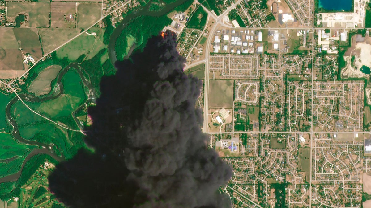 In this Satellite image provided by Planet Labs Inc., a huge plume of smoke and fires can be seen at the Chemtool Inc. plant near Rockton, Illinois, on Monday. A private firefighting company from Louisiana was expected to begin pumping fire-suppressing foam Tuesday onto the still-burning ruins of a northern Illinois chemical plant, a day after it was rocked by an explosion and massive fires, officials said. (Planet Labs Inc. via AP)