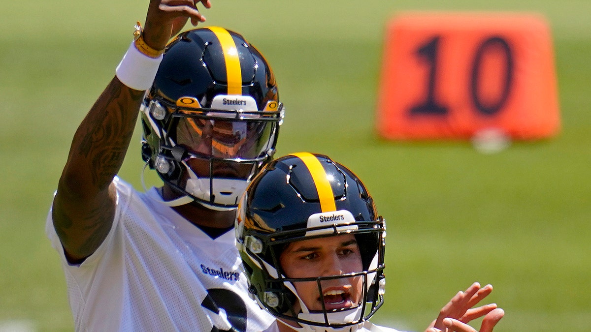 Pittsburgh Steelers quarterbacks Dwayne Haskins (3) and Mason Rudolph work during the team's NFL minicamp football practice in Pittsburgh, Thursday, June 17, 2021.