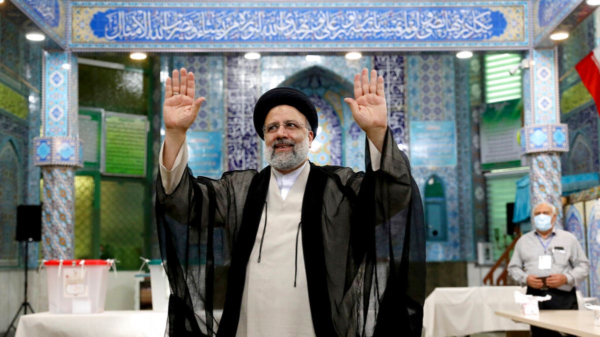 June 18, 2021: Ebrahim Raisi, a candidate in Iran's presidential elections waves to the media after casting his vote at a polling station in Tehran, Iran. (AP Photo/Ebrahim Noroozi)