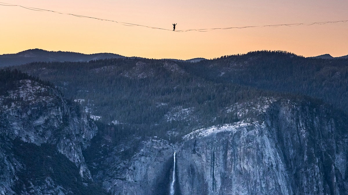 Highliner Daniel Monterrubio walks the 2,800-foot-long line off Taft Point above Yosemite Valley in Yosemite, Calif on June 12, 2021. (Scott Oller/Scott Oller Films via AP)