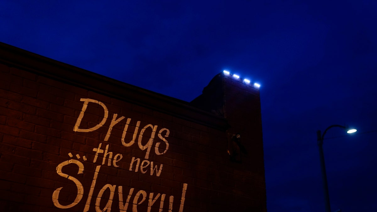 May 21, 2021: A sign painted on the side of a corner store reads, "Drugs... the new Slavery!" in St. Louis.