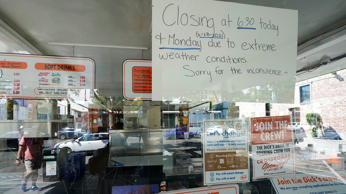 A sign in the window of the Dick's Drive-In in Seattle's Capitol Hill neighborhood is shown Monday, June 28, 2021, in Seattle. The walk- and drive-up restaurant, which is not air conditioned, closed early Sunday and all day Monday due to excessive heat. Seattle and other cities in the Pacific Northwest endured the hottest day of an unprecedented and dangerous heat wave on Monday, with temperatures obliterating records that had been set just the day before on Sunday. (AP Photo/Ted S. Warren)