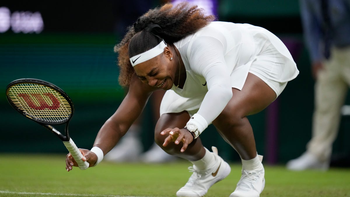 Serena Williams of the U.S. falls to the ground during the women's singles first- round match against Aliaksandra Sasnovich of Belarus on day two of the Wimbledon Tennis Championships in London, Tuesday June 29, 2021. (AP Photo/Kirsty Wigglesworth)