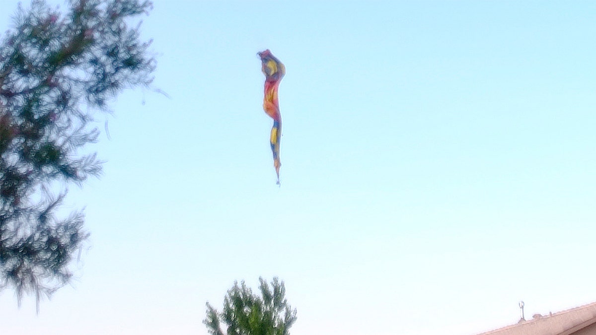 A hot-air balloon envelope falls from the sky near Unser and Central SW in Albuquerque, N.M., Saturday, June 26, 2021. Multiple people were killed in the crash.