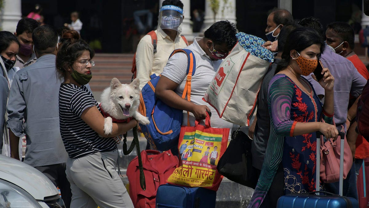 June 7, 2021: Passengers walk outside the New Delhi railway station in New Delhi. 