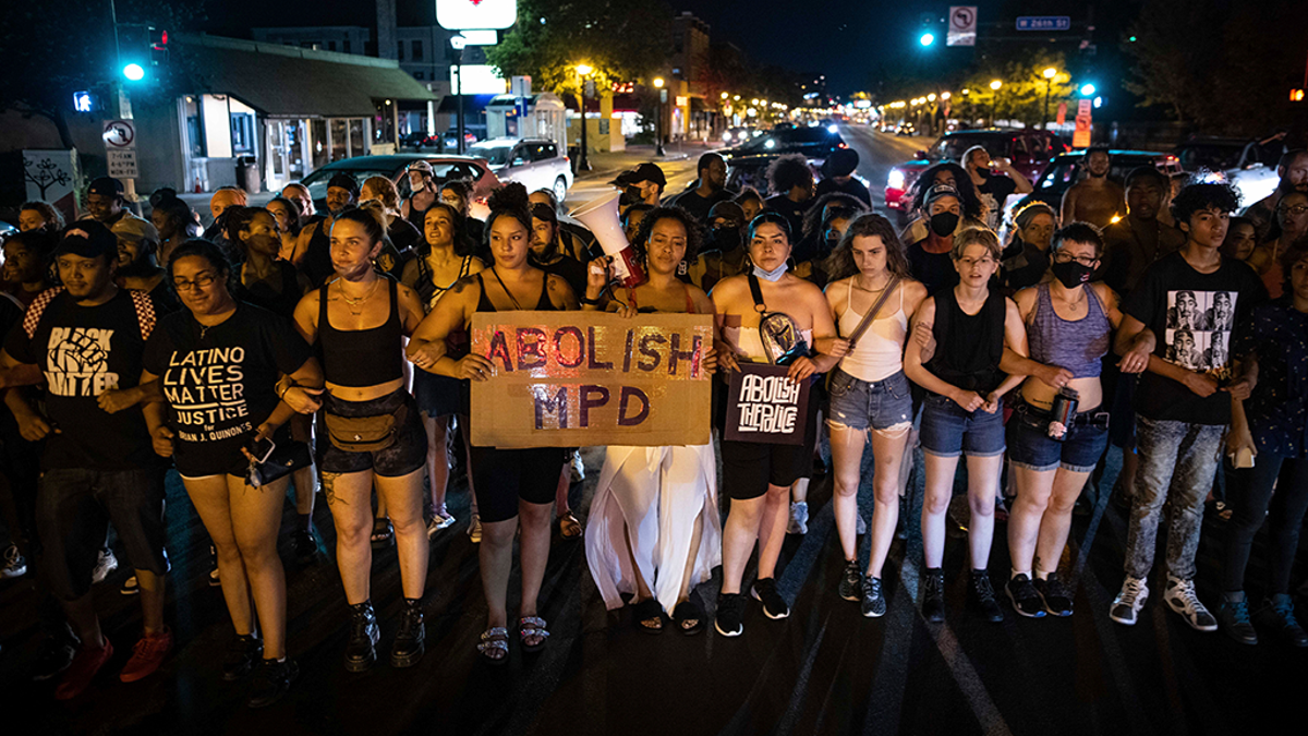 Dozens of community members march, Sunday, June 6, 2021, in Minneapolis, for Winston Boogie Smith Jr., who was fatally shot by members of a U.S. Marshals task force several days earlier. 