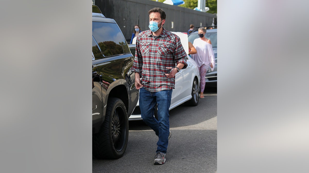 Affleck was previously photographed wearing the red and grey flannel.  (Photo by Bellocqimages/Bauer-Griffin/GC Images)