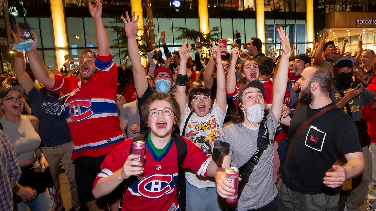 Montreal Canadiens fans celebrate on Rue Rene Levesque after the Montreal Canadiens defeated the Vegas Golden Knights in overtime in Game 6 of an NHL hockey Stanley Cup semifinal playoff series Thursday, June 24, 2021 in Montreal. (Peter McCabe/The Canadian Press via AP)