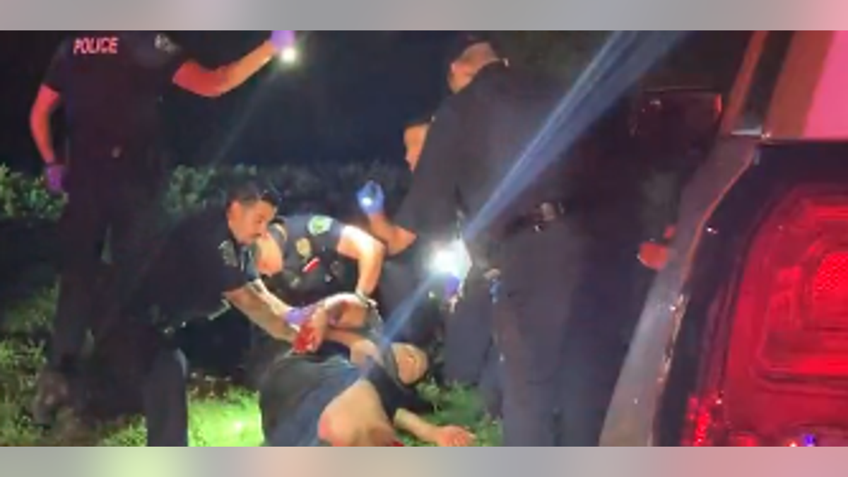 FOX 7 Austin news cameras recorded the same officers rendering lifesaving first aid to a shooting victim hours after the fire. (FOX 7 Austin)