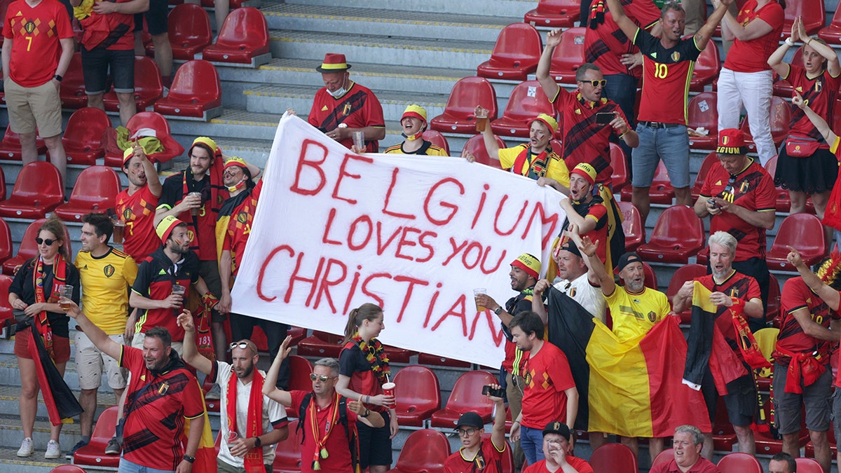 Belgium supporters hold a banner in support of Danish player Christian Eriksen ahead of the Euro 2020 soccer championship group B match between Denmark and Belgium at the Parken stadium in Copenhagen, Denmark, Thursday, June 17, 2021. Christian Eriksen was hospitalized after collapsing during Denmarks match with Finland. (Hannah McKay/Pool via AP)