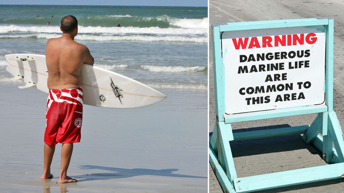 surfer next to warning sign