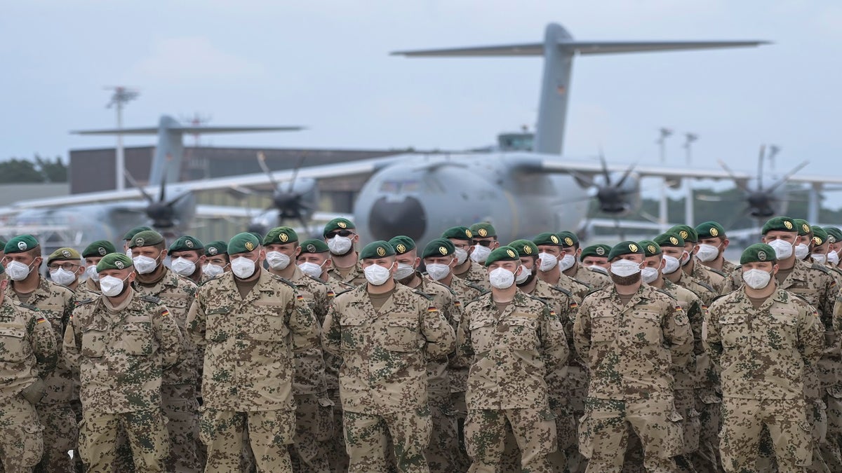 Soldiers of the German Armed Forces line up in front of the Airbus A400M transport aircraft of the German Air Force for the final roll call in Wunstorf, Germany, on Wednesday. The last soldiers of the German Afghanistan mission have arrived at the air base in Lower Saxony. (AP)