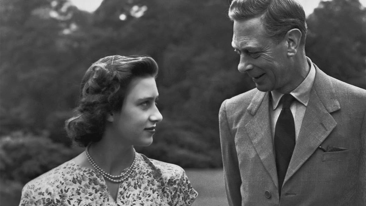 Princess Margaret (1930 - 2002) with her father King George VI (1895-1952) on the grounds of Windsor Castle in Windsor, England on July 8, 1946.
