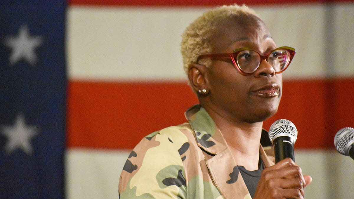 Nina Turner speaks with American flag in background