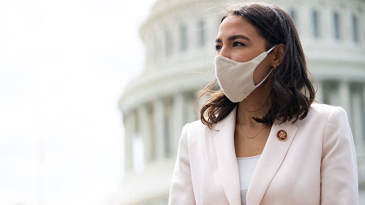 Rep. Alexandria Ocasio-Cortez attends a press conference about a postal banking pilot program outside the Capitol in Washington