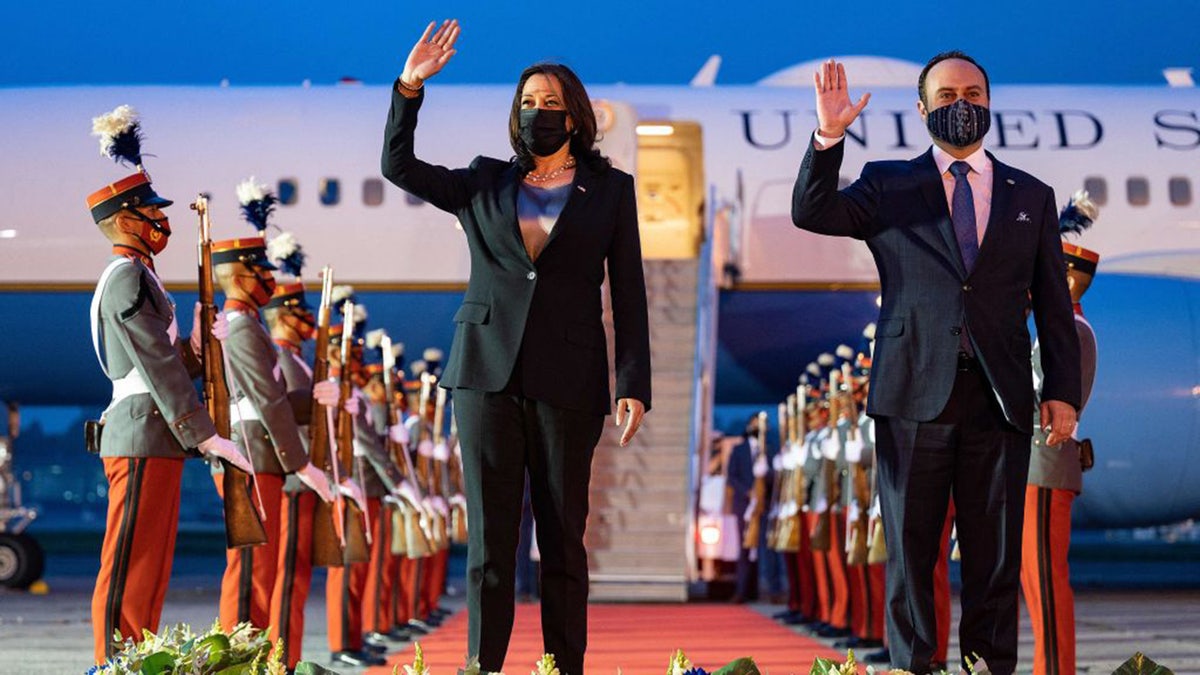 US Vice President Kamala Harris waves alongside Guatemalan Foreign Minister Pedro Brolo upon arrival in Guatemala City on June 6, 2021.