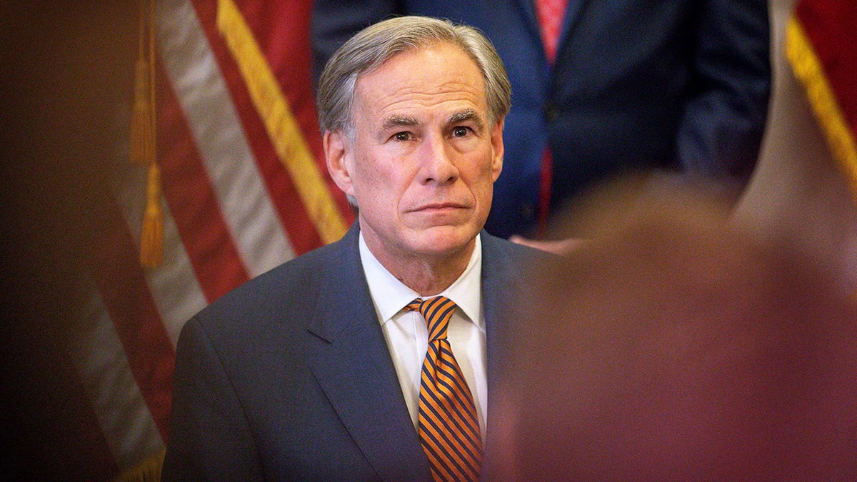 Texas Gov Greg Abbott wearing a suit and tie