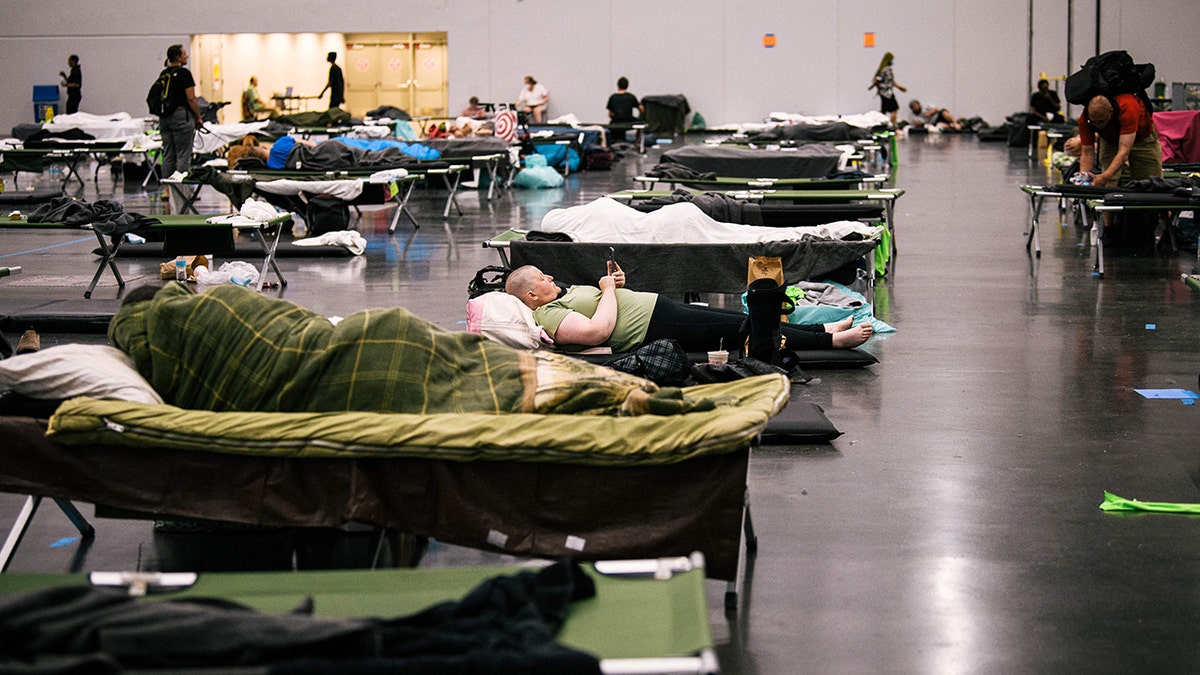 People rest at the Oregon Convention Center cooling station in Oregon, Portland on June 28, 2021, as a heatwave moves over much of the United States.