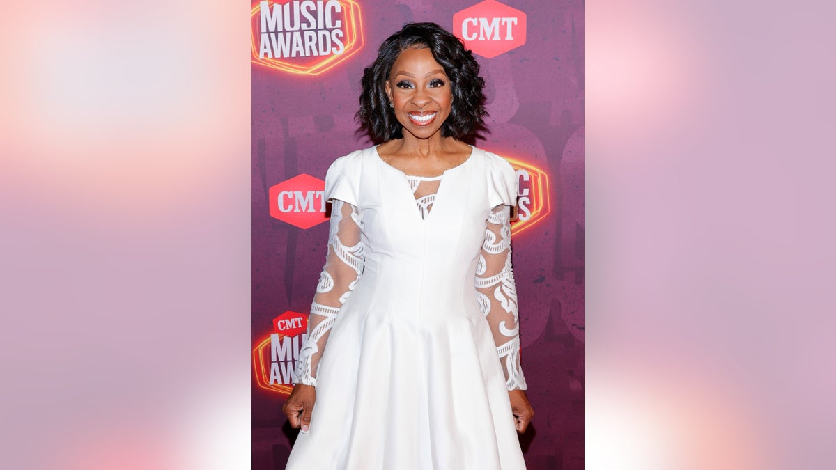 Gladys Knight hit the 2021 CMT Music Awards red carpet in a regal white dress. 