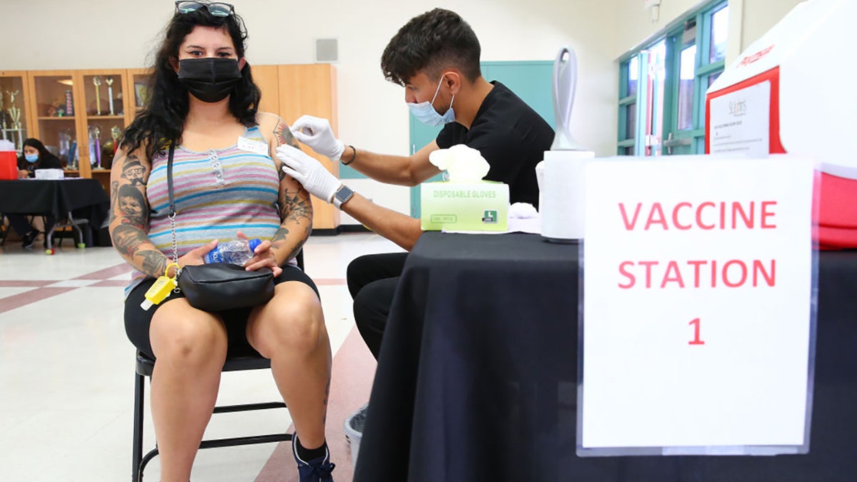 Wendy Ibarra prepares to receive her second COVID-19 vaccination dose at a vaccination clinic in South Los Angeles on June 25, 2021, in Los Angeles, California. (Photo by Mario Tama/Getty Images)