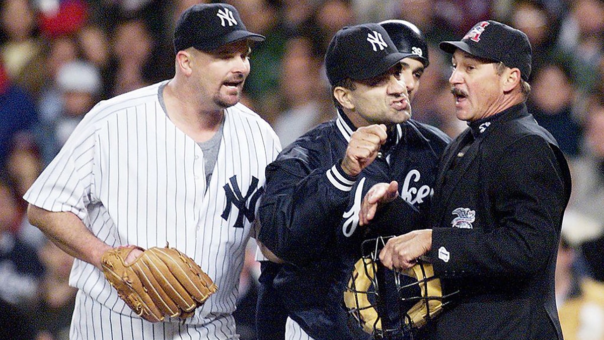 New York Yankee manager Joe Torre and pitcher David Wells argue with home plate umpire Jim Evans during the seventh inning of an American League Championship Series game at Yankee Stadium in New York. (DON EMMERT/AFP via Getty Images)